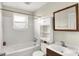 Bright bathroom featuring a white vanity, medicine cabinet, and a shower over tub at 3609 N Keystone Ave, Indianapolis, IN 46218