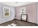 Bedroom with two windows, neutral carpeting, and light purple and tan paint at 3609 N Keystone Ave, Indianapolis, IN 46218