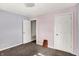 Bedroom with two closets, neutral carpeting, and light purple and tan walls at 3609 N Keystone Ave, Indianapolis, IN 46218