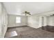 Spacious living room with ceiling fan, two closets with shelves and view of the neighboring dining area at 3609 N Keystone Ave, Indianapolis, IN 46218