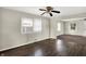 Cozy living room featuring hardwood floors, neutral paint colors, a ceiling fan, and a window A/C unit at 3609 N Keystone Ave, Indianapolis, IN 46218