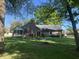 Expansive backyard view of the home featuring a deck, brick chimney, and a well-maintained lawn at 378 Turnberry Ct, Avon, IN 46123