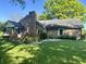 Beautiful brick home in the backyard features a spacious wooden deck and mature trees for outdoor enjoyment at 378 Turnberry Ct, Avon, IN 46123