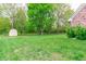 Spacious backyard features a storage shed and mature trees, offering ample space and a serene outdoor setting at 378 Turnberry Ct, Avon, IN 46123