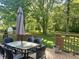 Inviting backyard deck with table and chairs offers serene views of the lush backyard and mature trees at 378 Turnberry Ct, Avon, IN 46123