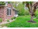 Well-maintained backyard featuring a brick house and mature trees for shade and privacy at 378 Turnberry Ct, Avon, IN 46123