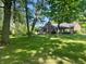 Lush backyard featuring a well-maintained lawn and mature trees, providing a private and serene setting at 378 Turnberry Ct, Avon, IN 46123