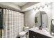 Well-lit bathroom featuring a single vanity, toilet, and shower with light-striped curtain at 378 Turnberry Ct, Avon, IN 46123
