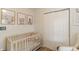 Charming Bedroom with soft-colored animal wall art, white crib, and chair with ottoman at 378 Turnberry Ct, Avon, IN 46123