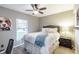 Inviting bedroom with soft natural light, ceiling fan, and views of the yard through the windows at 378 Turnberry Ct, Avon, IN 46123