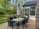 Outdoor deck featuring a glass-topped table, six chairs and an umbrella, perfect for outdoor dining and relaxation at 378 Turnberry Ct, Avon, IN 46123