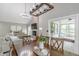 Dining room next to living room, stone fireplace, sliding doors to porch, and chandelier at 378 Turnberry Ct, Avon, IN 46123
