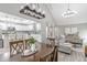 A dining room with a dark wood table opens to a living area and a modern kitchen space at 378 Turnberry Ct, Avon, IN 46123