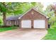 Spacious driveway leading to a two-car garage with traditional red brick exterior and trimmed in white at 378 Turnberry Ct, Avon, IN 46123