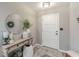 Welcoming foyer features a console table, round mirror, rug and bright lighting at 378 Turnberry Ct, Avon, IN 46123