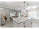 Kitchen with an island and seating opens to dining area with view of the backyard and living room at 378 Turnberry Ct, Avon, IN 46123