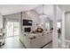 Bright living room with a stone fireplace, vaulted ceilings, and access to the back patio at 378 Turnberry Ct, Avon, IN 46123
