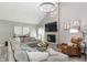 Comfortable living room boasts vaulted ceiling, stone fireplace, and stylish furnishings at 378 Turnberry Ct, Avon, IN 46123