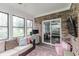 Brick sunroom featuring expansive windows, exposed brick, and sliding glass doors to the main house at 378 Turnberry Ct, Avon, IN 46123
