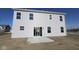 Two-story home with sliding glass door and light gray siding and rectangular windows on upper and lower floors at 3942 Seeger St, Indianapolis, IN 46239