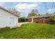 Spacious backyard features green grass and a detached garage at 4013 Priscilla Ave, Indianapolis, IN 46226