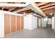 This basement has white-painted walls and an unfinished area with framing at 4013 Priscilla Ave, Indianapolis, IN 46226