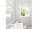 Bright bathroom features a white sink and a window with natural light at 4013 Priscilla Ave, Indianapolis, IN 46226