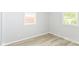 Bedroom with two windows and light colored wood flooring at 4013 Priscilla Ave, Indianapolis, IN 46226