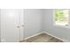 Bright bedroom features wood-look floors, a window and a closet with white doors at 4013 Priscilla Ave, Indianapolis, IN 46226