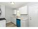 Updated kitchen features bright white cabinets and a stainless steel sink at 4013 Priscilla Ave, Indianapolis, IN 46226
