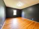 Bedroom with dark walls, wood floors and window views at 406 Frst Pk N Dr, Greenwood, IN 46142
