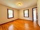 Bedroom with wood floors, two windows and a door to the hallway at 406 Frst Pk N Dr, Greenwood, IN 46142