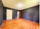 Bedroom with wood floors, dark walls and a closet at 406 Frst Pk N Dr, Greenwood, IN 46142
