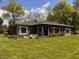 Charming single-story home with well-manicured lawn, mature trees, and a welcoming front porch at 406 Frst Pk N Dr, Greenwood, IN 46142