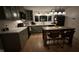 Cozy kitchen showcasing sage green cabinets, quartz countertops, and a central kitchen island at 406 Frst Pk N Dr, Greenwood, IN 46142
