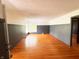 Spacious living room featuring warm hardwood floors and ample natural light at 406 Frst Pk N Dr, Greenwood, IN 46142