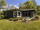 Side view of a single story home with mature landscaping at 406 Frst Pk N Dr, Greenwood, IN 46142