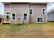 Tan two-story home exterior featuring horizontal siding, multiple windows, and a small wooden deck at 4075 Persian St, Greenwood, IN 46143