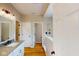 Bathroom boasts single sink vanity, granite countertop, and glass enclosed shower with wood look tile floors at 4075 Persian St, Greenwood, IN 46143