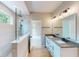 Bathroom boasts double sink vanity, granite countertop, with glass enclosed shower and wood look tile floors at 4075 Persian St, Greenwood, IN 46143