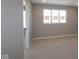 Light-filled bedroom with neutral carpeting, a large window, and doorway to a closet at 4075 Persian St, Greenwood, IN 46143