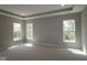 Bright bedroom with three windows providing ample natural light and neutral carpet at 4075 Persian St, Greenwood, IN 46143