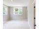 Bright, carpeted bedroom with two windows and neutral walls at 4075 Persian St, Greenwood, IN 46143