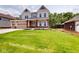 Inviting two-story home with a well-manicured lawn and a convenient three-car garage at 4075 Persian St, Greenwood, IN 46143
