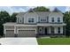 Charming two-story home with a three-car garage, covered porch, and manicured lawn in a picturesque setting at 4075 Persian St, Greenwood, IN 46143