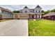 Traditional two-story home with a three-car garage and a long, paved driveway at 4075 Persian St, Greenwood, IN 46143