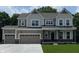 Charming two-story home with a three-car garage, covered porch, and manicured lawn in a picturesque setting at 4075 Persian St, Greenwood, IN 46143