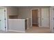 Neutral carpeted hallway with white doors and trim, leading to other parts of the home at 4075 Persian St, Greenwood, IN 46143