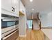 Modern kitchen features stainless steel appliances, white cabinetry and seamlessly connects with the staircase at 4075 Persian St, Greenwood, IN 46143