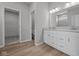 Bathroom featuring double vanity sinks, large mirror, and walk-in closet access at 4076 Berry Chase Blvd, Greenwood, IN 46143